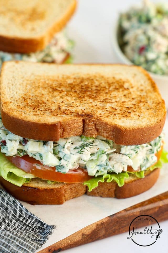 Chicken salad sandwich on toasted bread with lettuce and tomato.