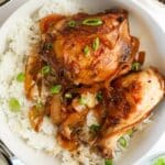Cooked chicken adobo in a large white serving bowl.