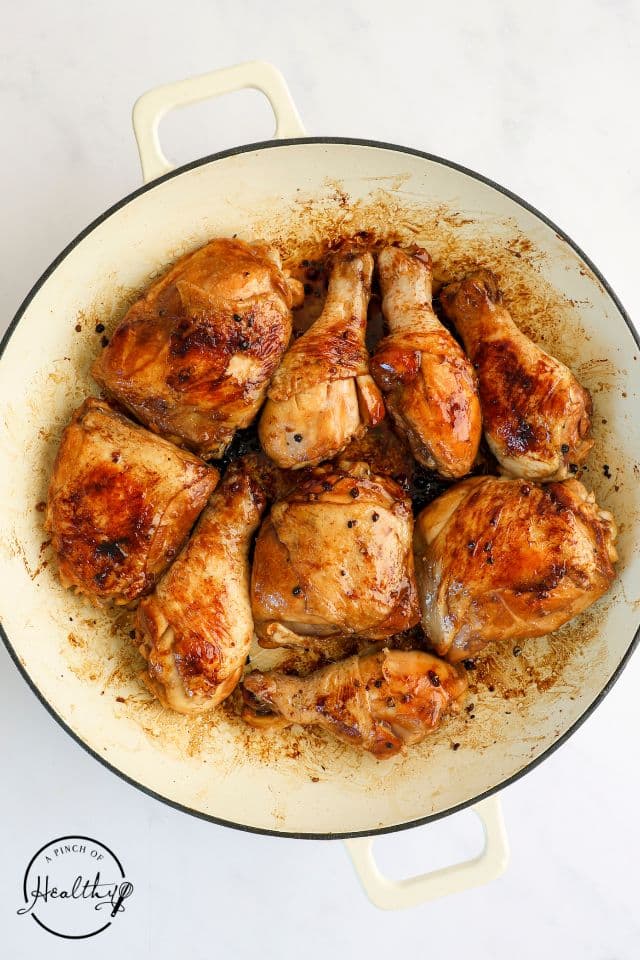 Marinated chicken for chicken adobo after being seared in a large skillet.
