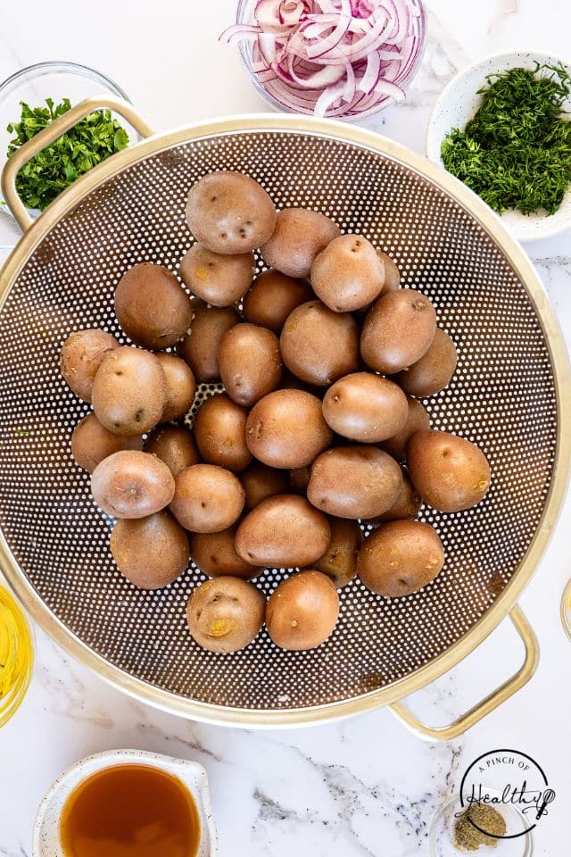 Cooked potatoes in a colander.