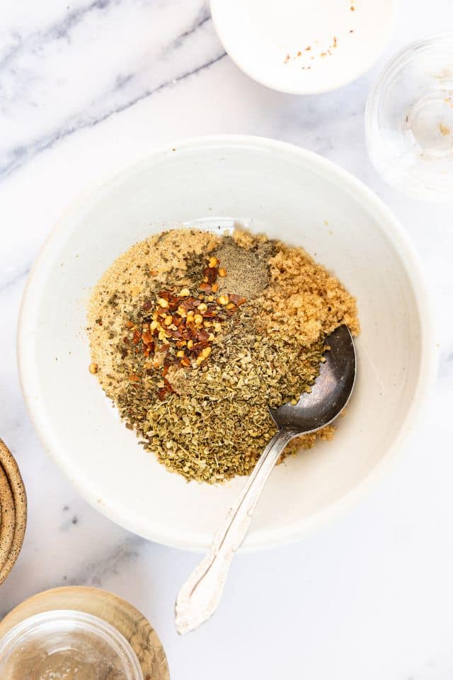 Spice rub for rotisserie chicken in a white bowl.