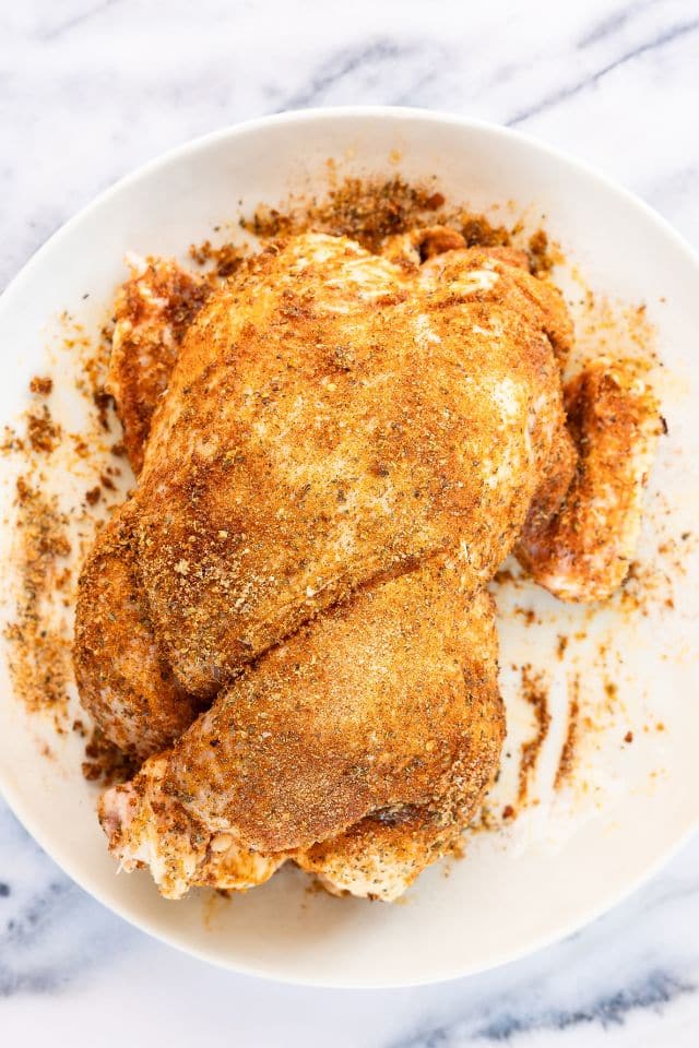 Seasoned rotisserie chicken before being cooked.