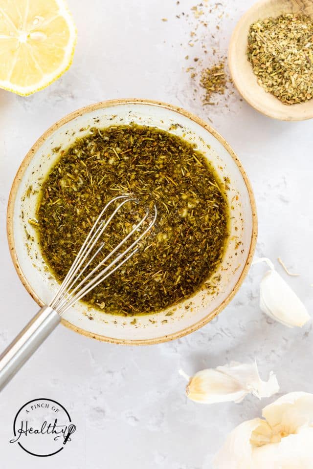 Chicken marinade in a bowl with a whisk.
