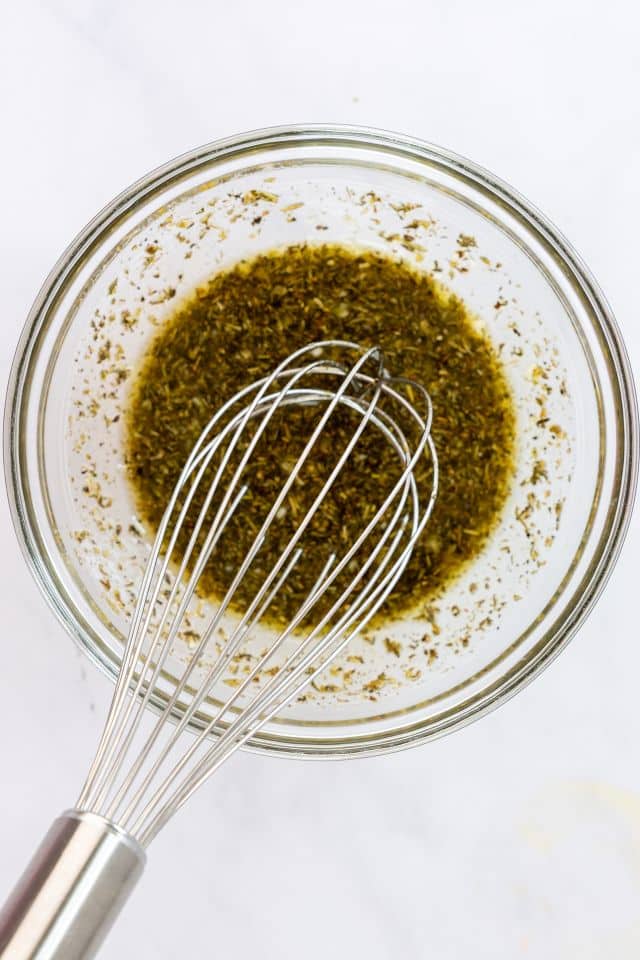 Chicken marinade after being whisked together in a glass bowl.