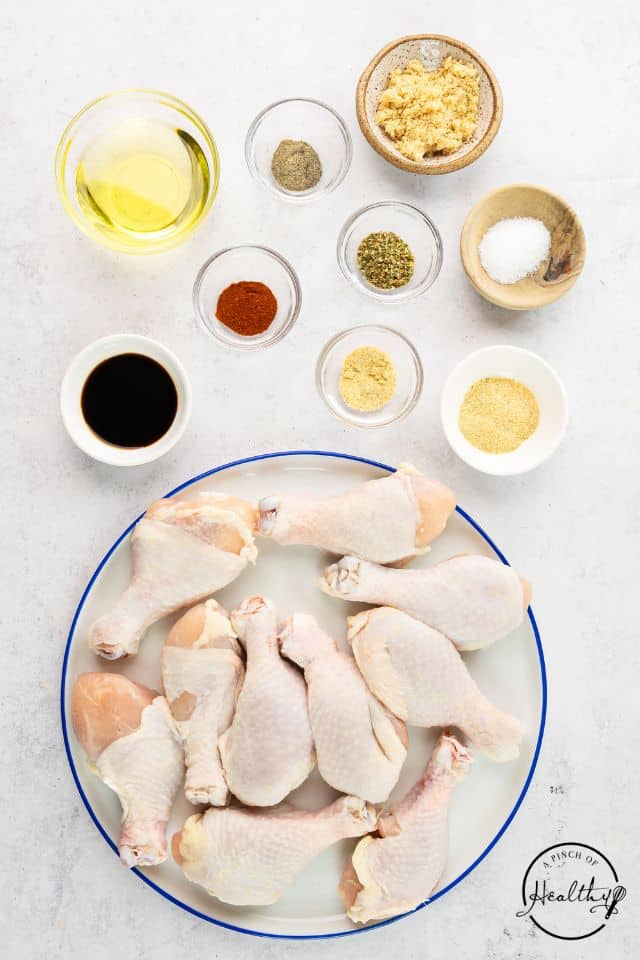 Ingredients for butterflied chicken legs in separate containers.