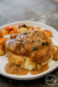 Smothered chicken with roasted root vegetables and mashed potatoes