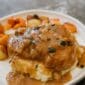Smothered chicken with roasted root vegetables and mashed potatoes