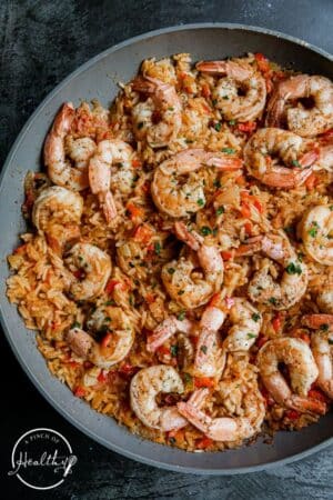 Cajun shrimp and rice in a skillet with parsley on top